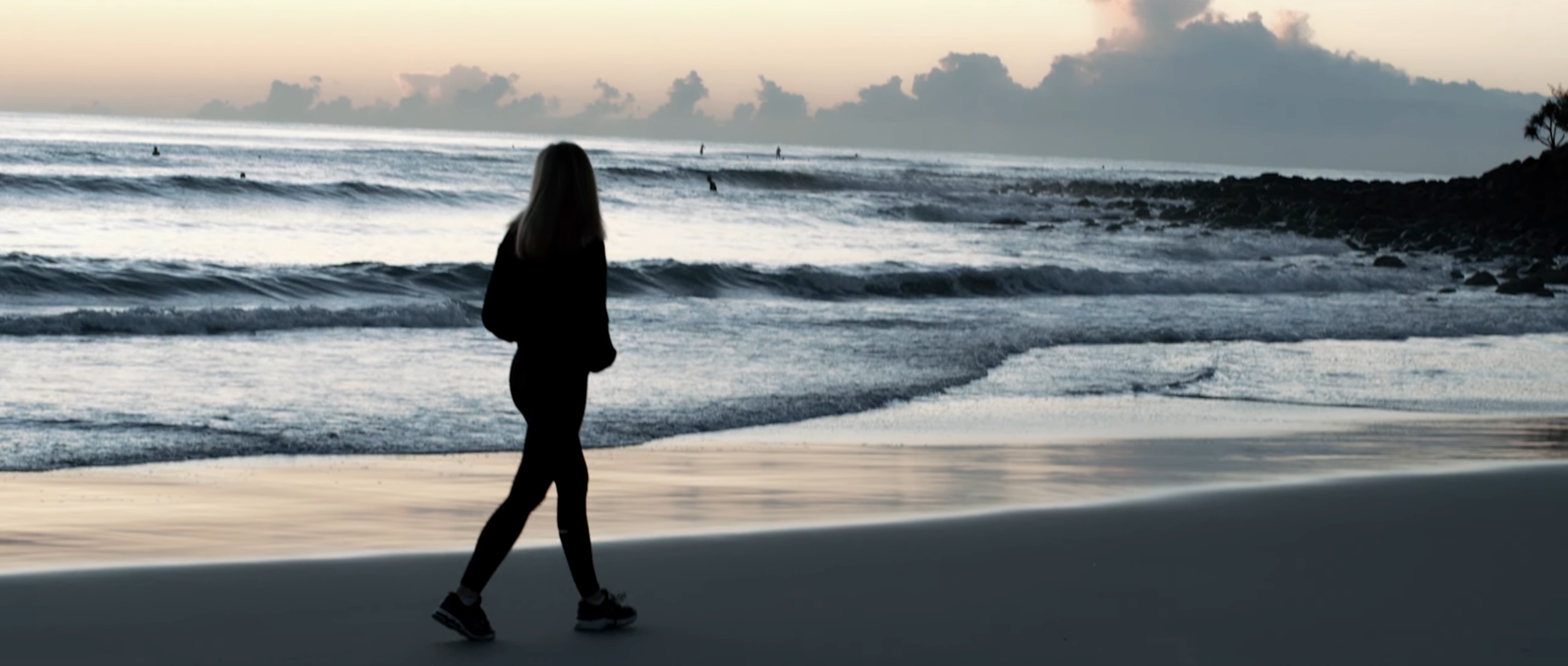 Stephanie walking on a beach