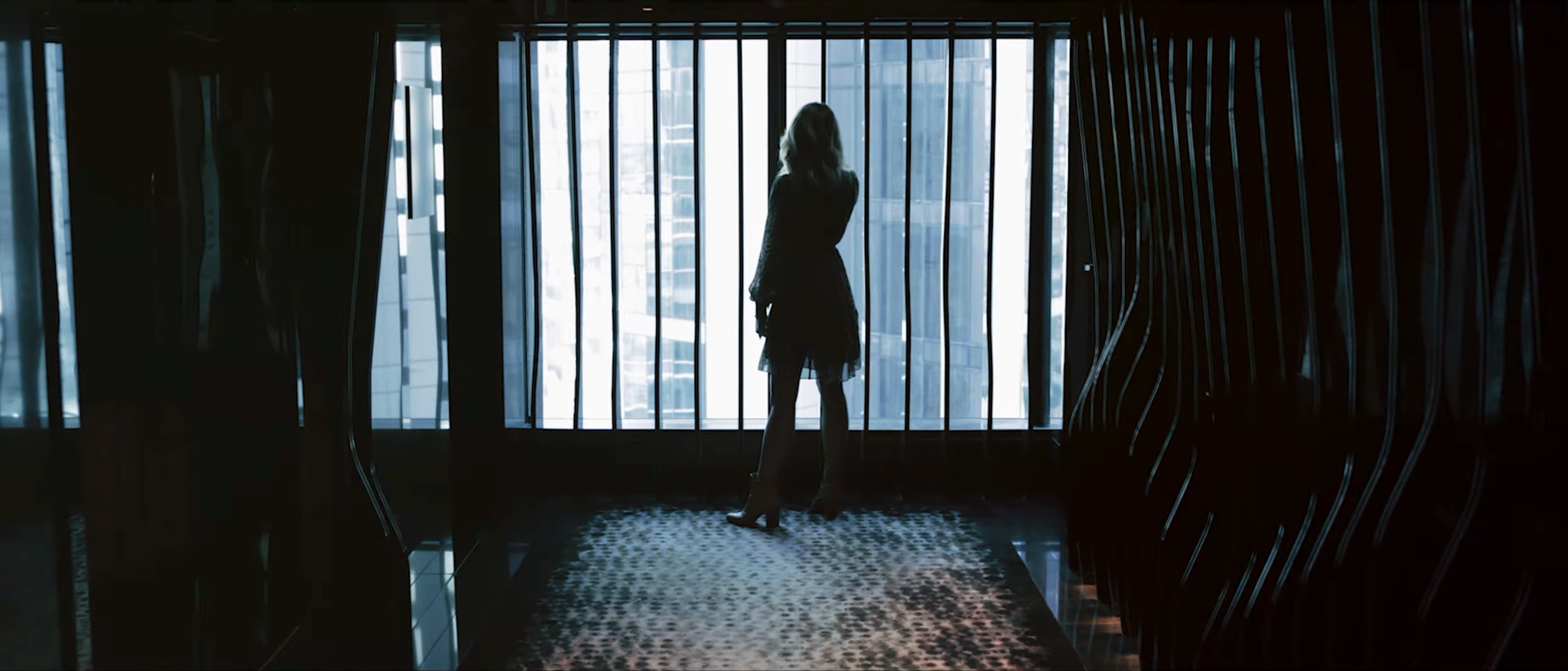 Stephanie standing by a window with her back turned